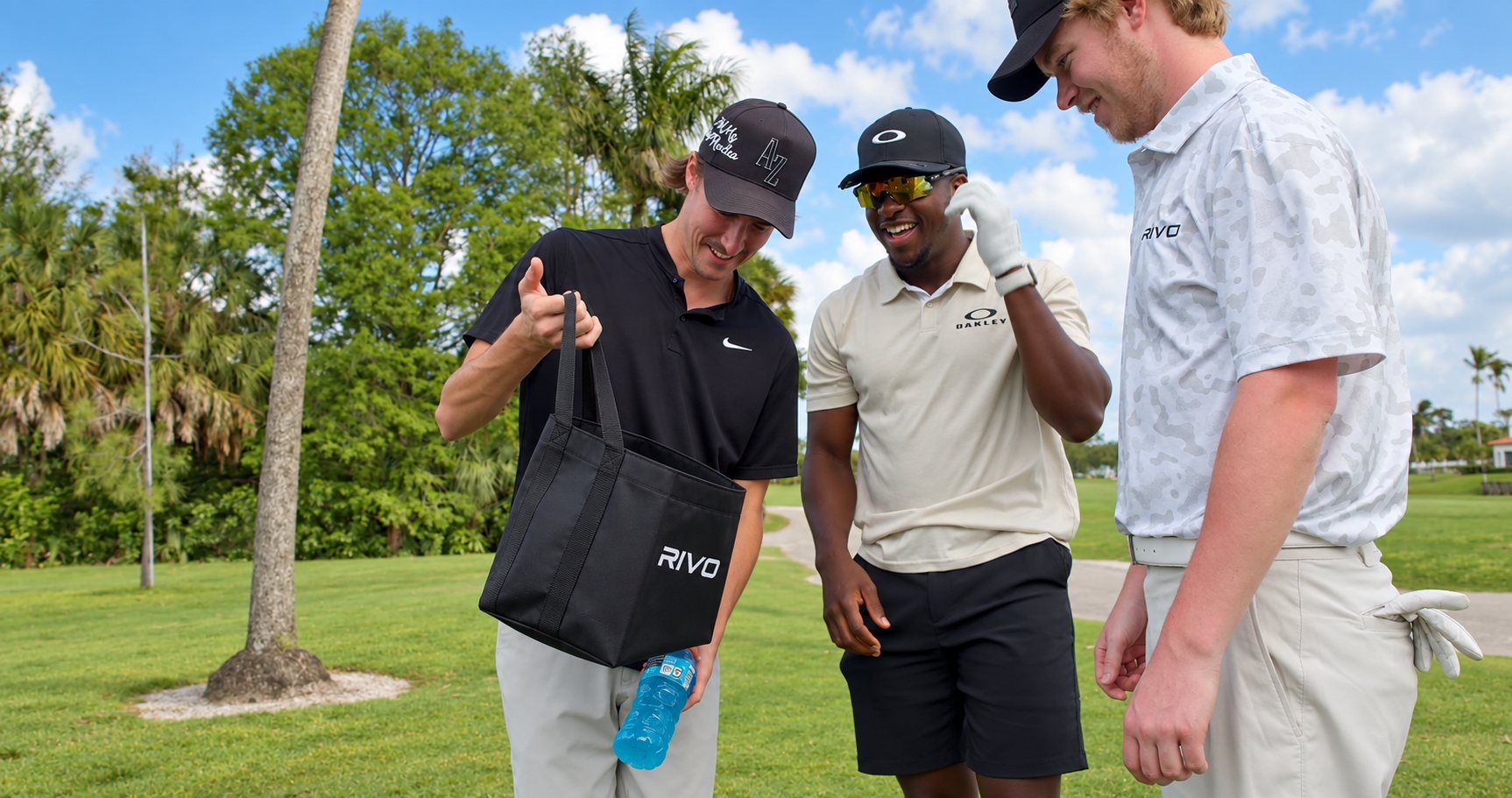 Golfers opening a Rivo delivery bag on the course